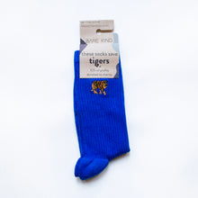 folded flat lay of saphire blue ribbed tiger socks with embroidered tiger motif on the cuff in 100% recyclable cardboard packaging