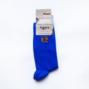 folded flat lay of saphire blue ribbed tiger socks with embroidered tiger motif on the cuff in 100% recyclable cardboard packaging