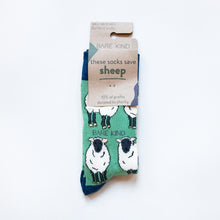 folded flat lay of green sheep bamboo socks in 100% recyclable cardboard packaging
