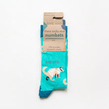 folded flat lay of bright blue numbat socks in 100% recyclable cardboard packaging