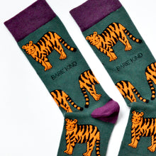 cuff closeup of flat lay of green tiger bamboo socks with purple cuff