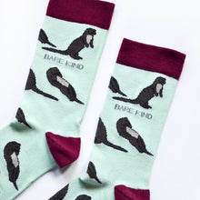 cuff closeup flat lay of pastel green otter socks 