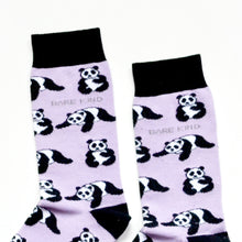 cuff closeup flat lay of lilac and black panda socks 