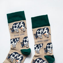 cuff closeup flat lay of cream and green cow bamboo socks
