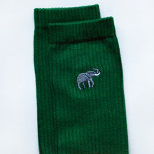 cuff closeup of flat lay of emerald green ribbed bamboo socks with embroidered elephant motif on the cuff