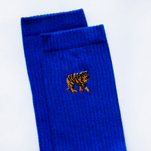 cuff closeup of indigo blue ribbed tiger socks with embroidered tiger motif on the cuff