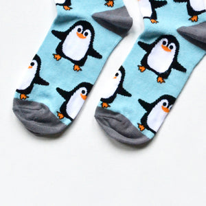toe closeup flat lay of sky blue bamboo socks with woven penguin design