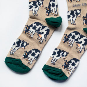 toe closeup flat lay of cream and green cow bamboo socks