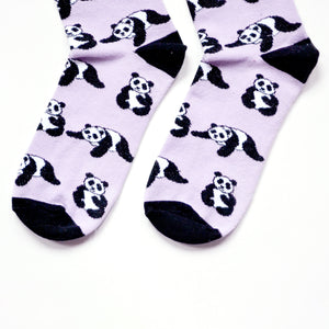 toe closeup flat lay of lilac and black panda socks 