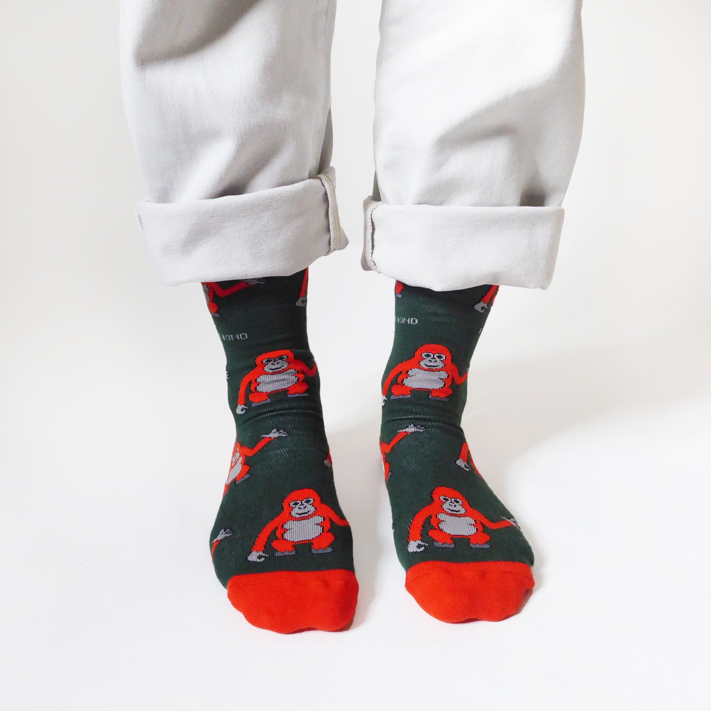 standing model wearing dark green orangutan socks, front view