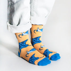 side angle view of standing model wearing coral ray socks