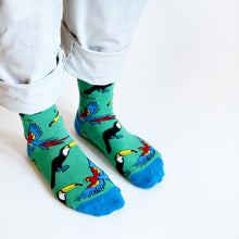 standing model, side angle view, wearing green and blue toucan bamboo socks