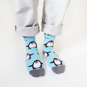 standing model wearing sky blue bamboo penguin socks