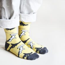 standing model, side angle view, wearing pastel yellow shark socks