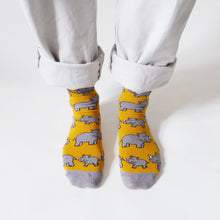 standing model wears yellow rhino bamboo socks