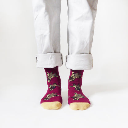 standing model wearing burgundy bamboo socks in giraffe print, front view