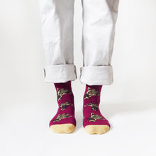 standing model wearing burgundy bamboo socks in giraffe print, front view