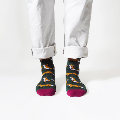 front view of standing model wearing dark green fox socks