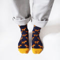 standing model wearing navy blue bamboo socks featuring leopard designs