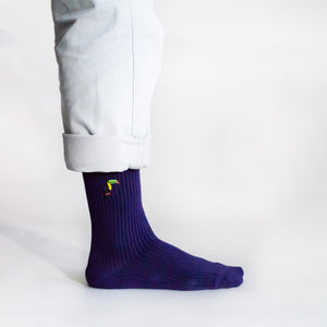 minimalist side view of ribbed purple bamboo socks featuring embroidered toucan motif on the cuff