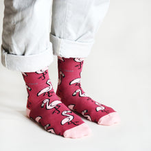 standing model wearing hot pink flamingo socks, side view