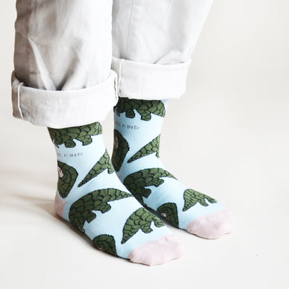 side angle view of standing model wearing pastel blue pangolin socks