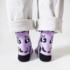 standing model wearing lilac panda socks, back view showing black heels