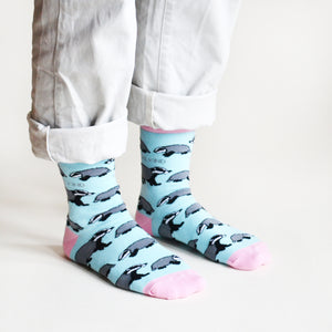 model wearing blue and pink badger socks, side angle view