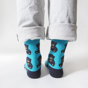 heel view of standing model wearing blue sun bear bamboo socks