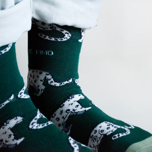 closeup of standing model wearing snow leopard bamboo socks