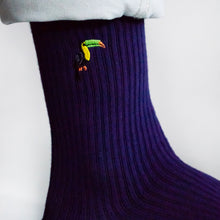 closeup of ribbed purple bamboo socks with embroidered toucan motif