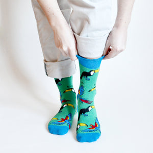 standing model pulling blue cuff of toucan bamboo socks