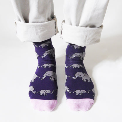 birds eye view of standing model wearing purple and pink bamboo elephants socks