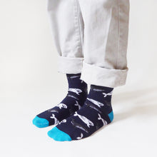 side angle view of standing model wearing blue whale socks