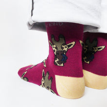 side angle view of standing model wearing burgundy bamboo socks in giraffe print