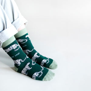 sitting model wearing bamboo snow leopard socks, side angle view