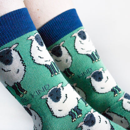 closeup of model wearing green sheep bamboo socks