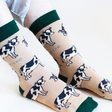 Model side angle view closeup wearing cream and green bamboo cow socks