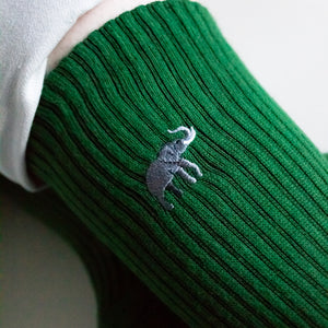 closeup of embroidered animal motif on emerald green ribbed bamboo socks
