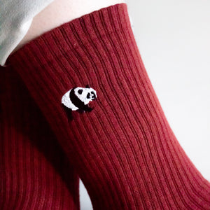 closeup of embroidered panda motif on the ribbed red bamboo sock cuff