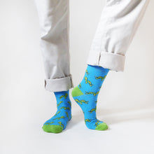 standing model wearing bamboo turtle socks with the left heel up
