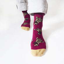 closeup of standing model wearing bamboo giraffe socks. the left foot is forward, highlight the burgundy bamboo sock