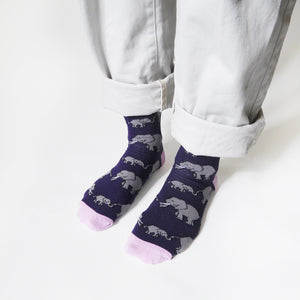 side angle view of standing model wearing purple and pink bamboo elephant socks