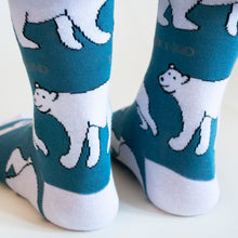 heel view of standing model wearing blue and white polar bear bamboo socks